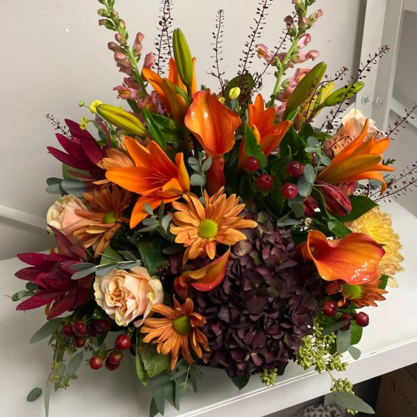 Mixed bouquet with orange lilies, hydrangea, roses, and calla lilies