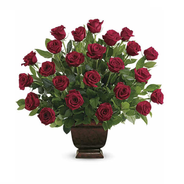 Red roses arranged in a dark pedestal vase