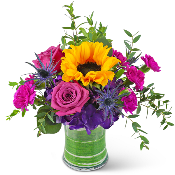 Mixed bouquet with yellow sunflower, purple rose, hot pink carnations, and blue thistle in a glass vase
