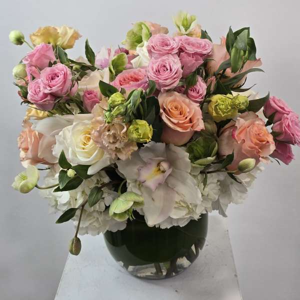 Pink and white rose bouquet in a glass vase