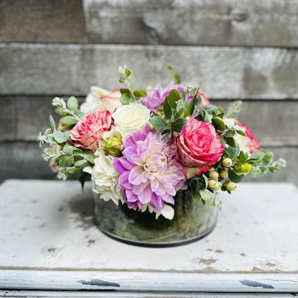 Pink and white mixed flower arrangement in a glass vase