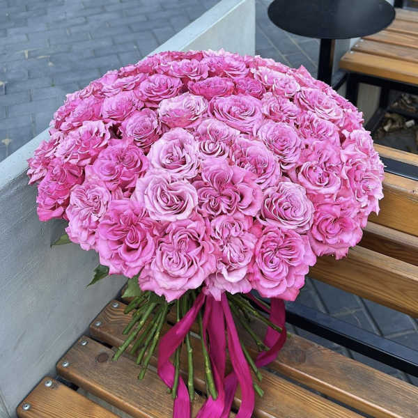 Large bouquet of pink roses tied with a magenta ribbon
