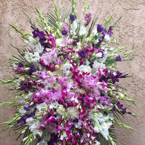Large standing spray of purple, pink, and white flowers