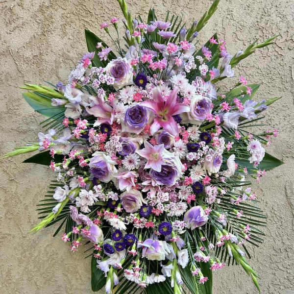 Large standing floral spray with pink and lavender blooms