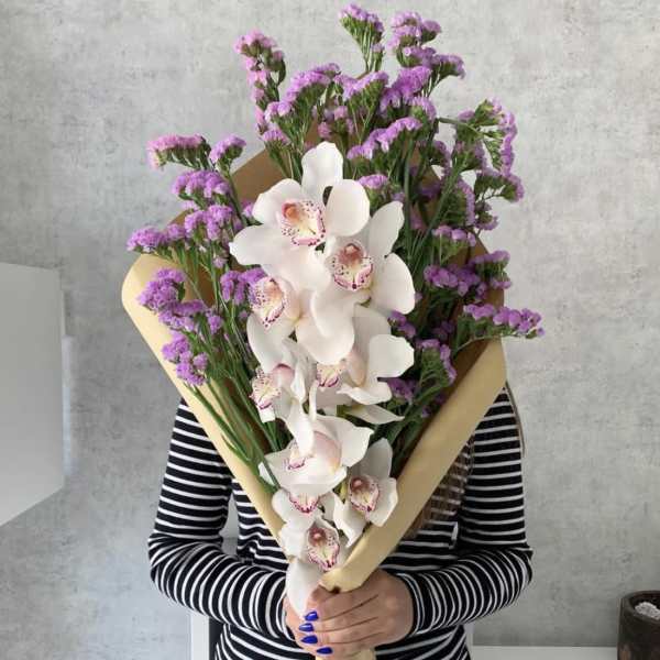 Large bouquet of white orchids and purple filler flowers