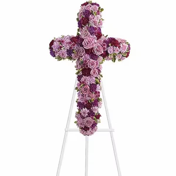 Purple and pink floral cross on a stand