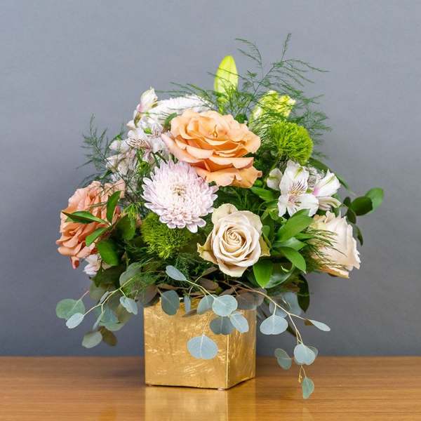 Peach and white rose bouquet in a gold box vase