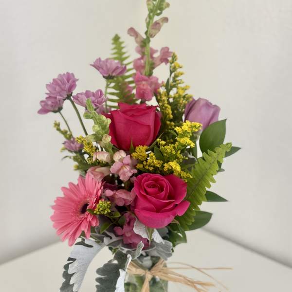 Pink and purple mixed bouquet in a glass vase