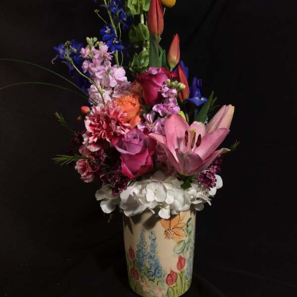 Colorful mixed bouquet in a painted ceramic vase