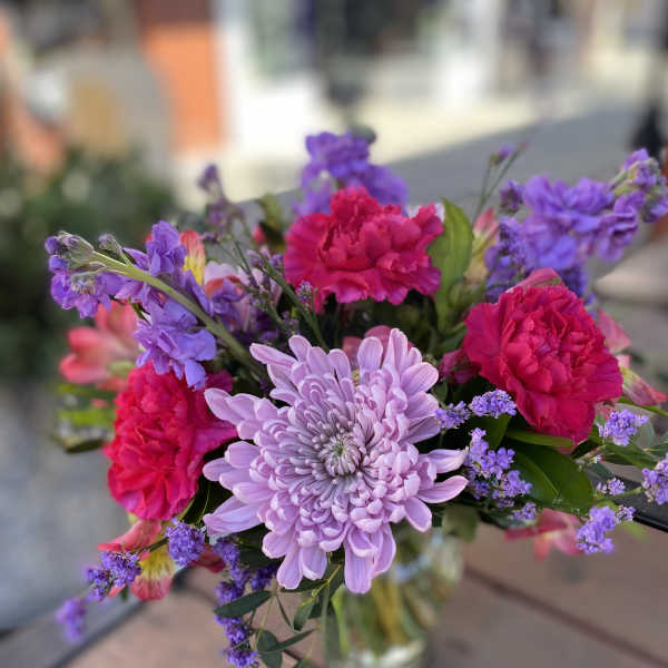 Bouquet of pink and lavender flowers in a glass vase