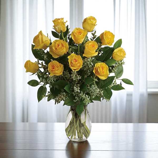 Yellow roses arranged in a clear glass vase