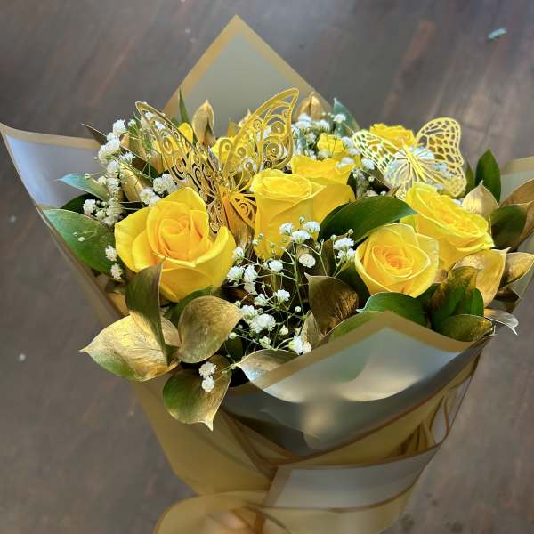 Bouquet of yellow roses with baby’s breath and gold butterfly accents