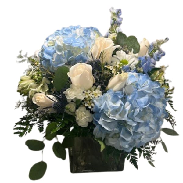Blue hydrangeas and white roses in a dark vase
