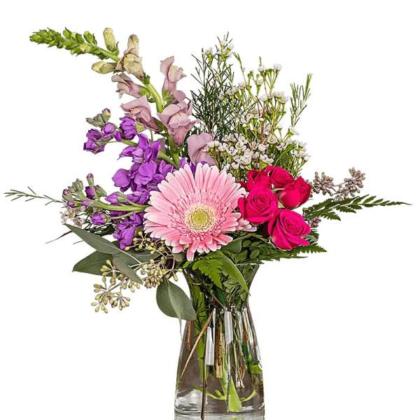 Mixed pink and purple flowers in a clear glass vase