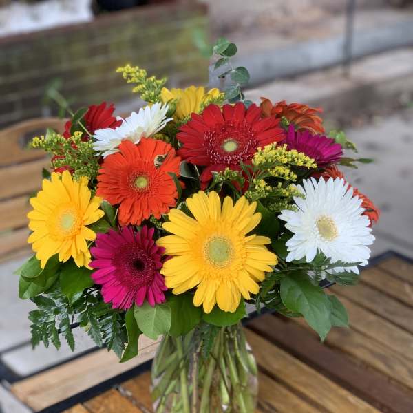Colorful gerbera daisy bouquet in a clear glass vase