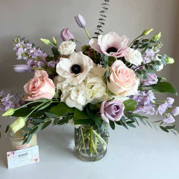 Bouquet of pale pink and white flowers in a glass vase