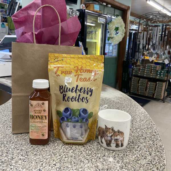 Gift bag with honey, blueberry rooibos tea, and a fox mug