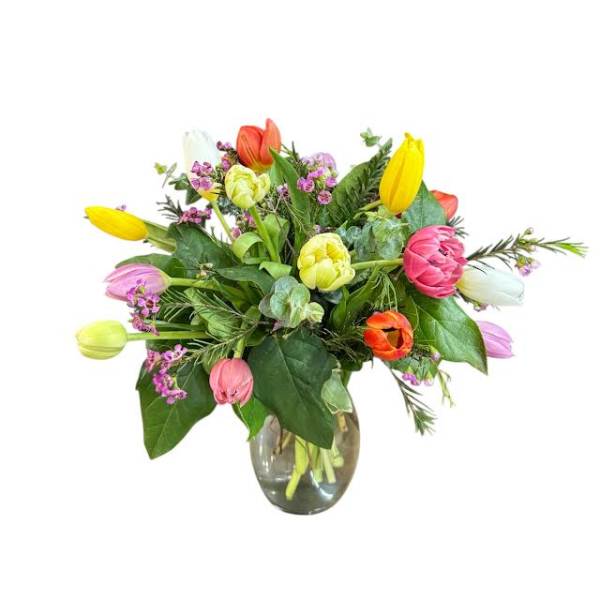 Colorful tulip bouquet in a clear glass vase