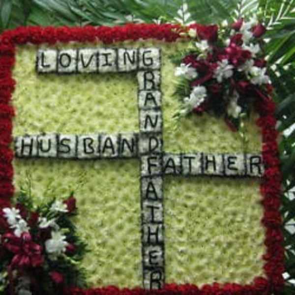 Floral tribute with the words Loving Husband Father