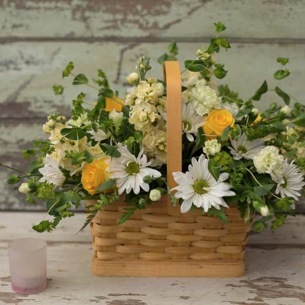 Basket arrangement with white daisies and yellow roses