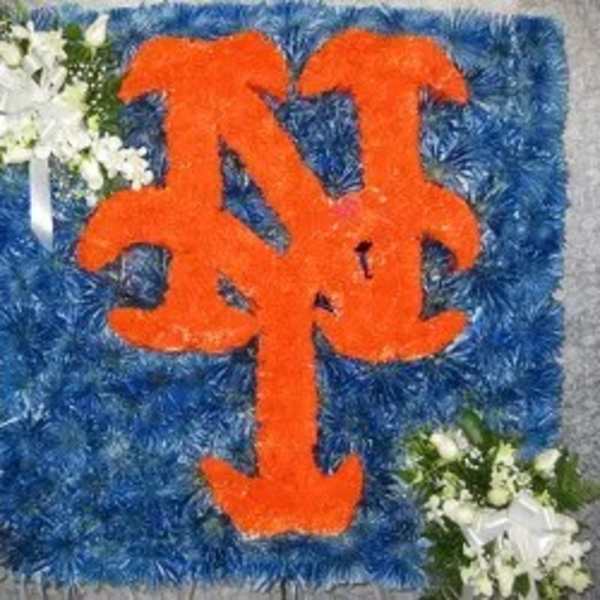 Blue floral tribute with orange monogram and white flower clusters