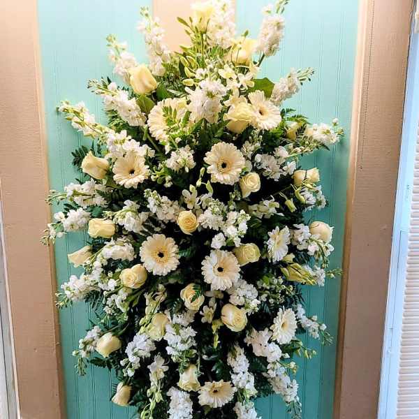 Tall white floral spray with cream roses and daisies