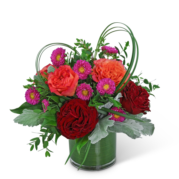 Bouquet of red and orange roses with purple daisies in a glass vase
