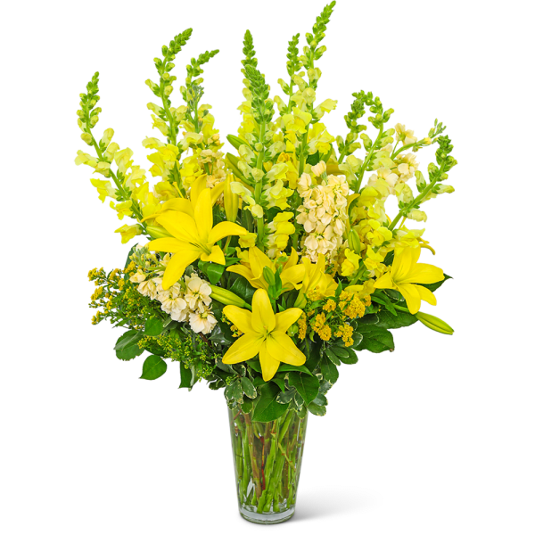Yellow lilies and snapdragons in a clear glass vase