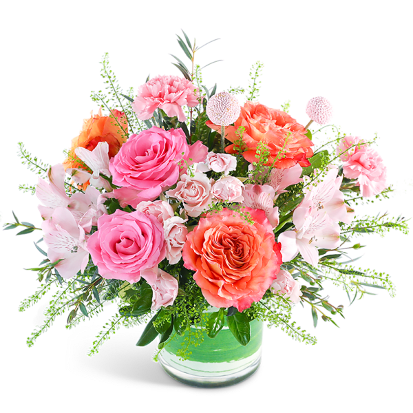 Pink and coral mixed bouquet in a glass vase