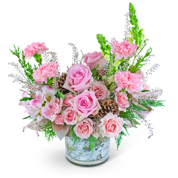 Pink roses and carnations in a glass vase with pinecones