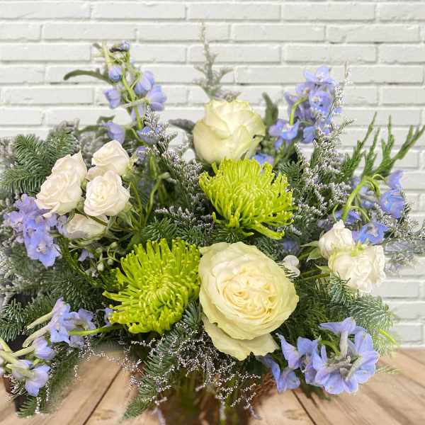 Bouquet of white roses, green spider mums, and blue flowers