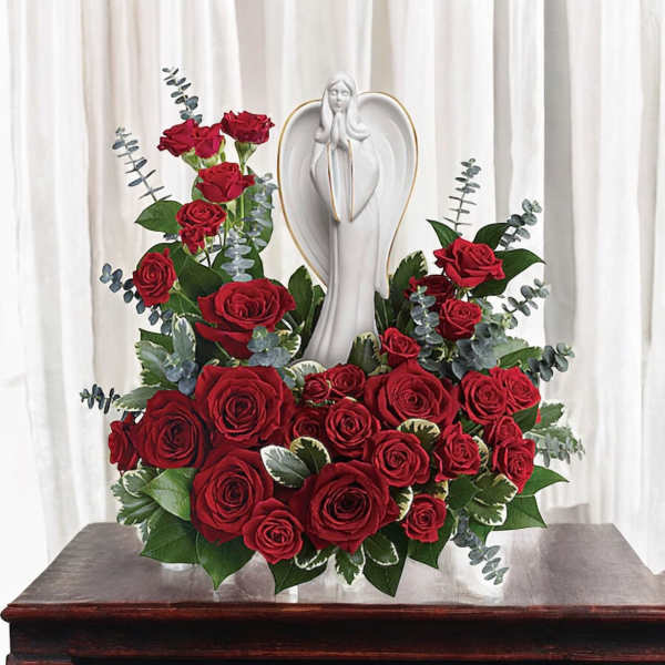 Red rose arrangement with a white angel statue centerpiece