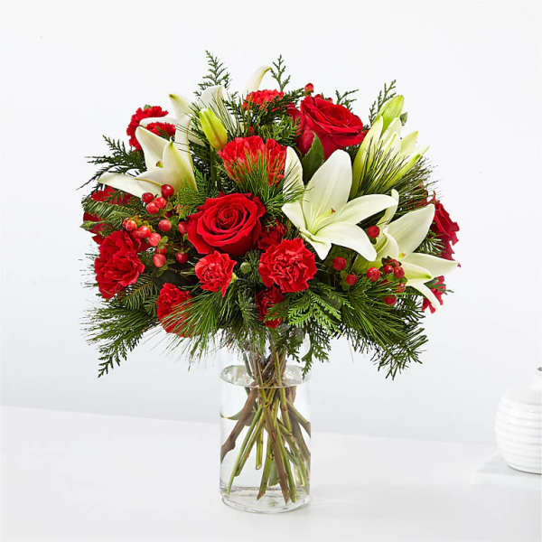 Red roses and white lilies in a clear glass vase