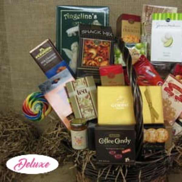 Basket of assorted snack and candy gift boxes with lollipops