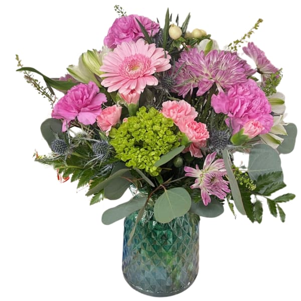 Pink and purple mixed bouquet in a blue glass vase
