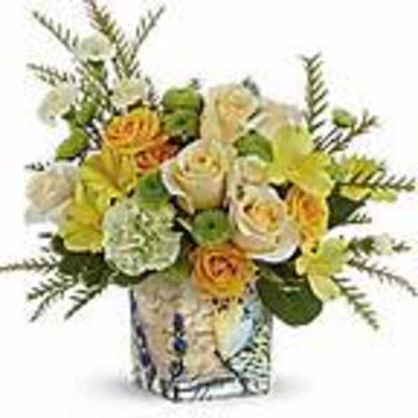 Bouquet of yellow and white flowers in a patterned vase
