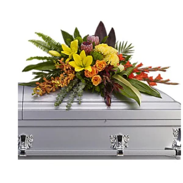 Colorful floral spray on a silver casket