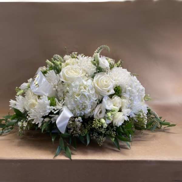 White floral casket spray with roses and chrysanthemums