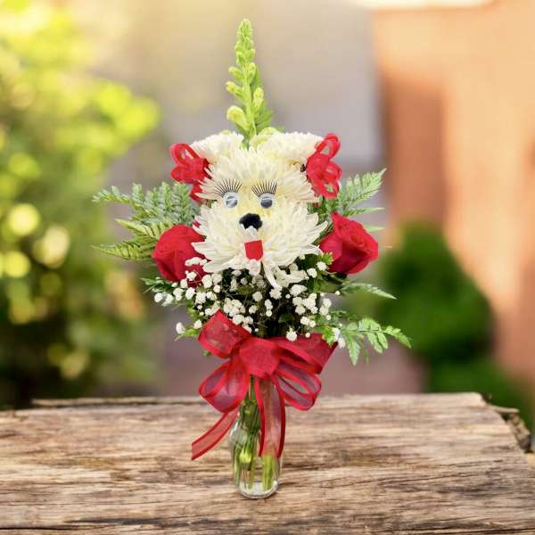 Bouquet in a glass vase shaped like a teddy bear with red ribbon accents