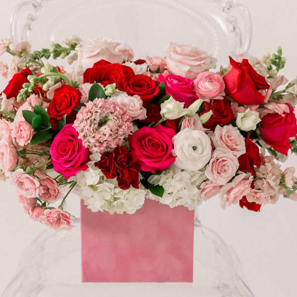 Pink and red rose arrangement in a pink box