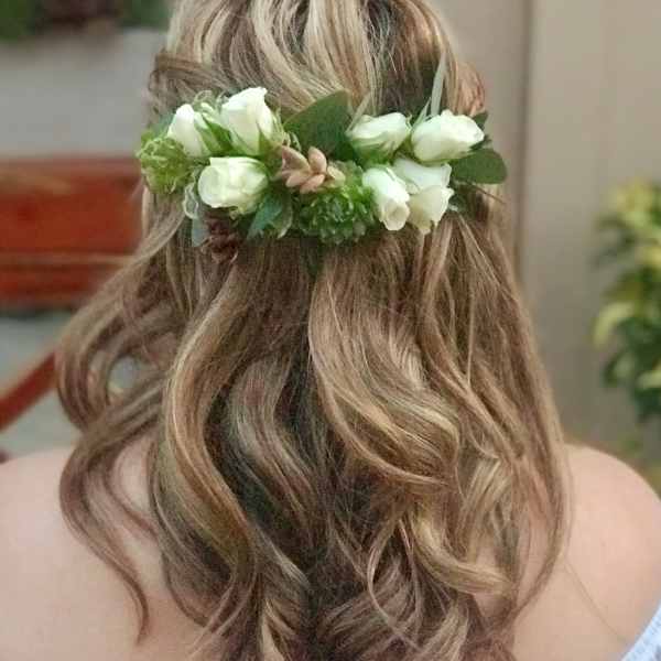Woman wearing a white floral hair crown in her hair
