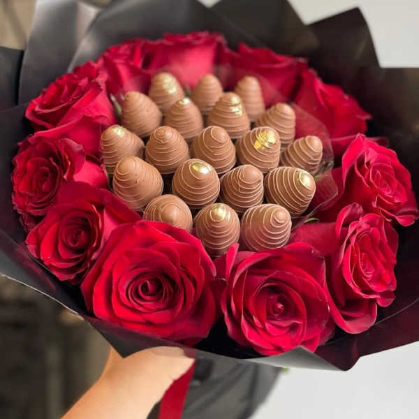 Bouquet of red roses surrounding chocolate truffles