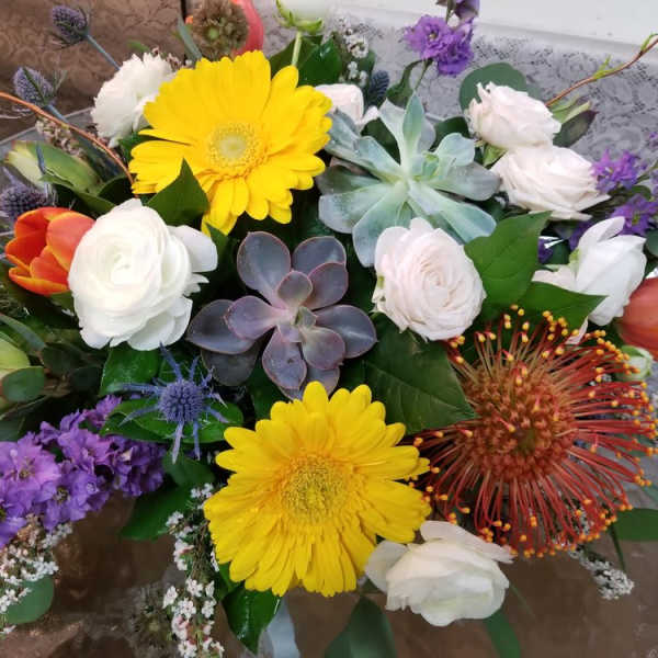 Mixed bouquet with yellow gerbera daisies, white roses, and purple flowers