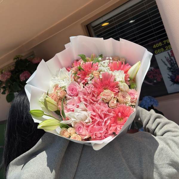 Pink and white mixed bouquet wrapped in white paper