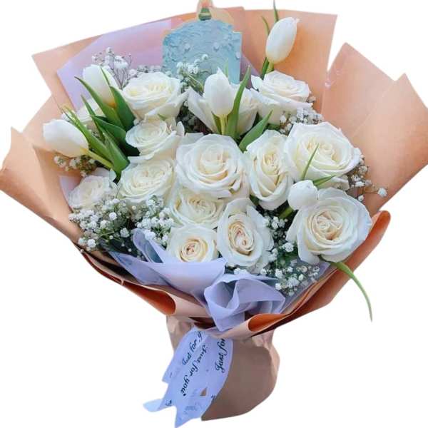 Bouquet of white roses and white tulips wrapped in pastel paper