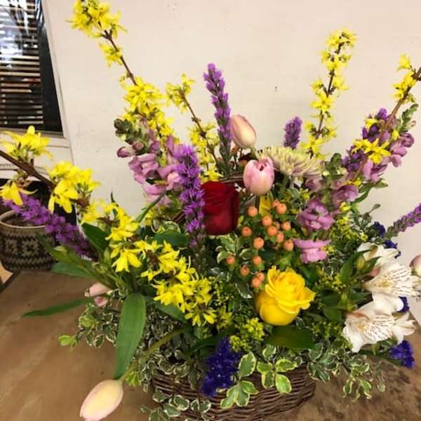 Mixed flower basket with yellow, purple, pink, and white blooms