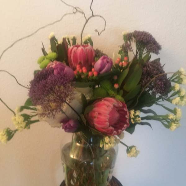Bouquet of pink and purple flowers in a glass vase