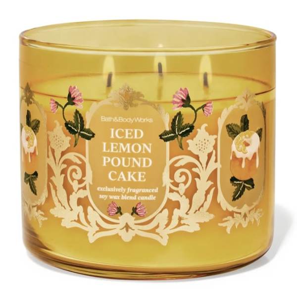 Amber glass candle jar with three wicks and floral label