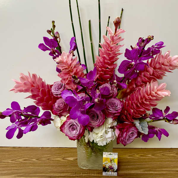 Pink and purple floral arrangement in a glass vase