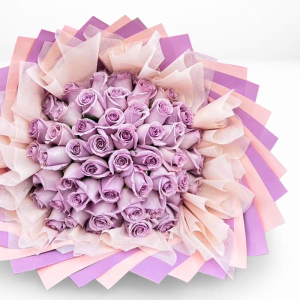 Bouquet of lavender roses wrapped in pink and purple paper